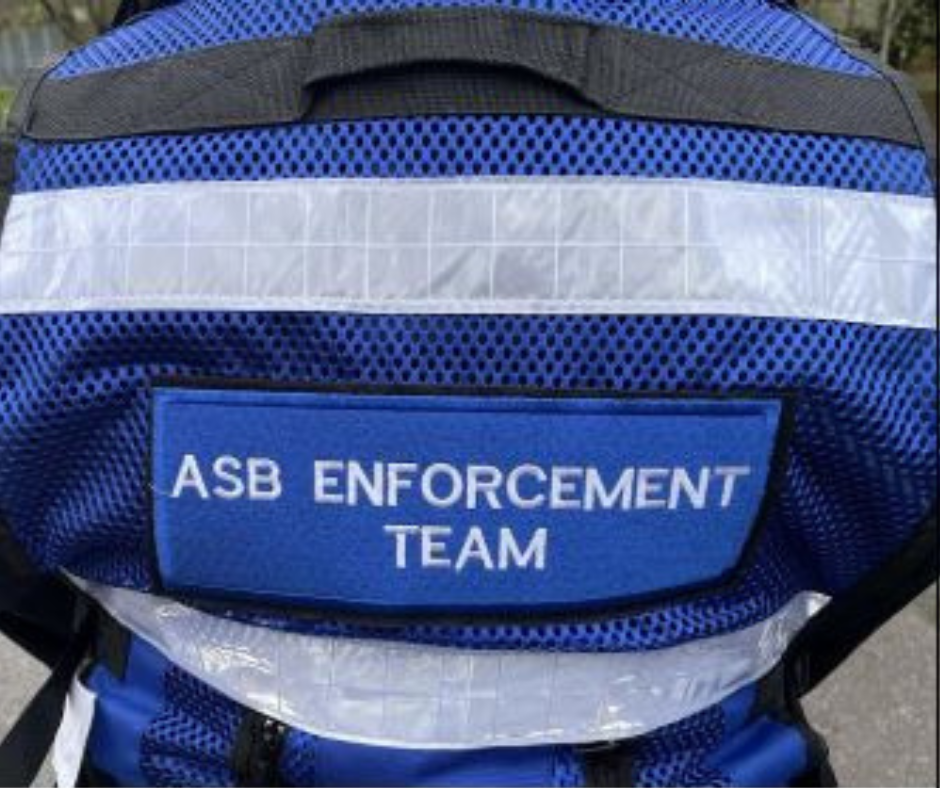 A blue jacket back with text ASB enforcement team