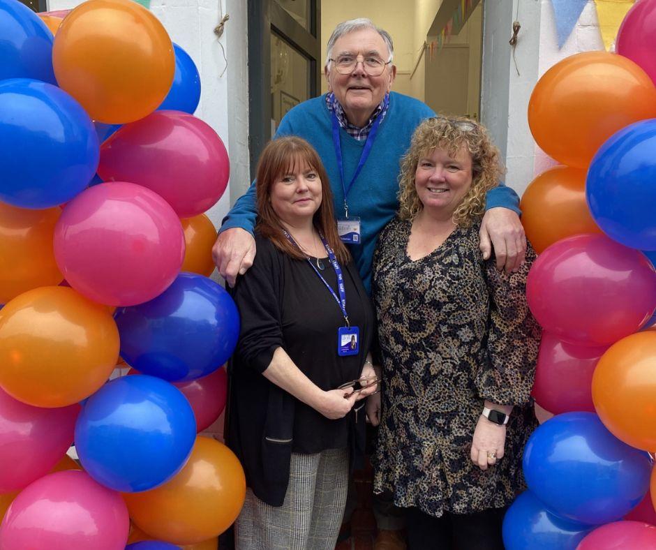 The founders of Babons charity surrounded by colourful balloons.
