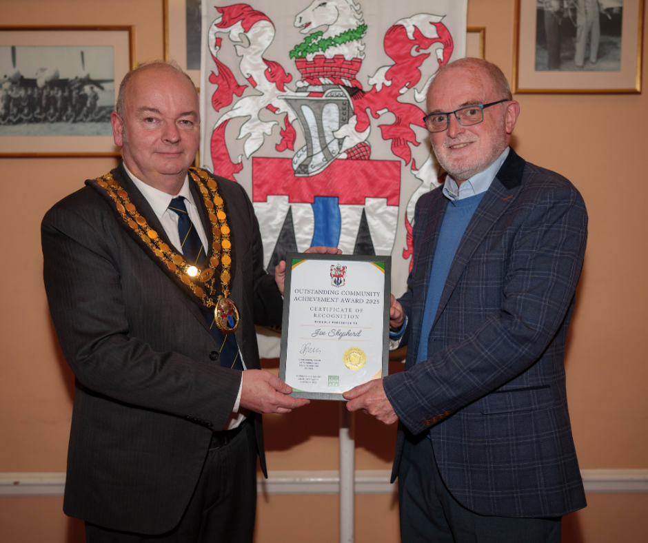Mayor Chris Brown presents Joe Shepherd with his award.