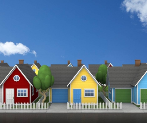 A row of brightly coloured houses beneath a blue sky.