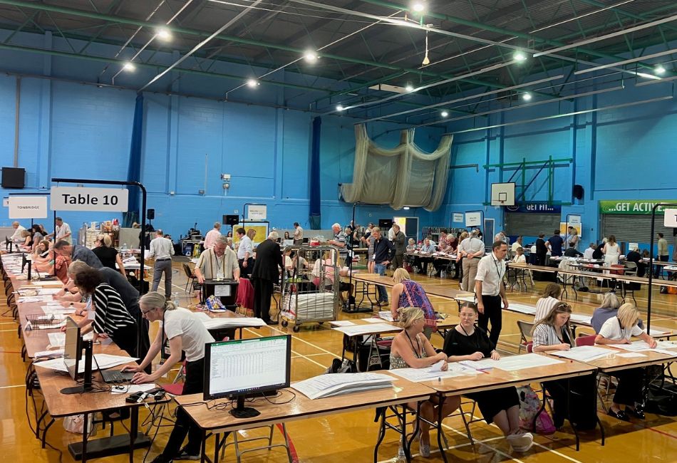 Sports hall with vote counters at tables