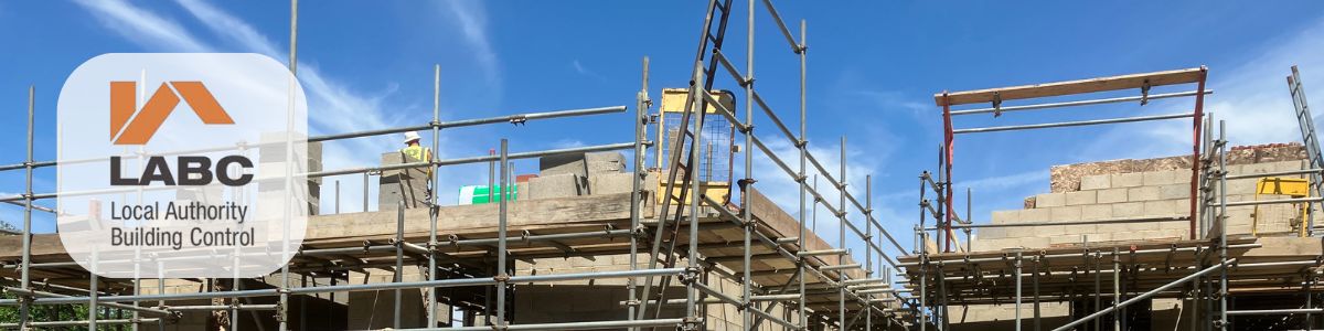 Banner image of houses under construction, also featuring the LABC Font Door Logo (Local Authority Building Control logo)
