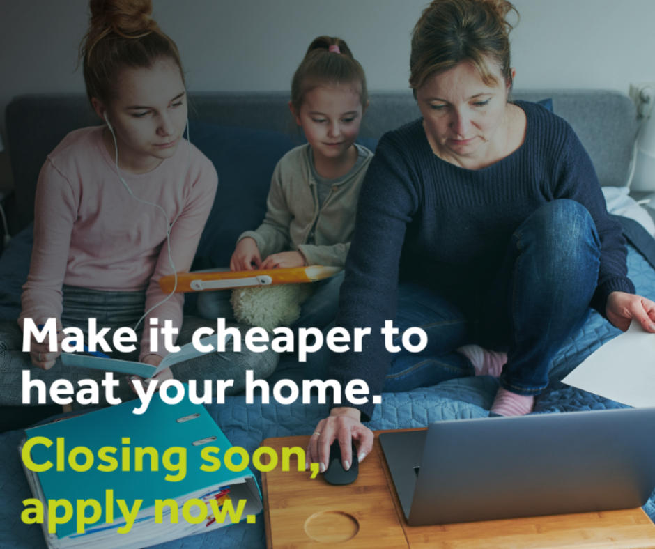 A woman with two children looking at a laptop.