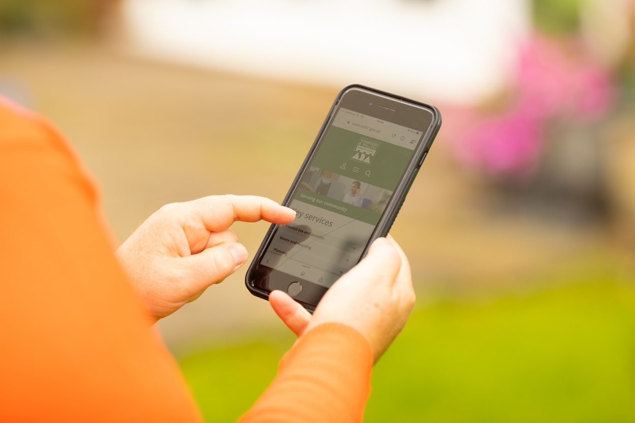 Woman using mobile phone to report an issue