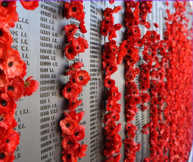 Red poppies on a war memorial.
