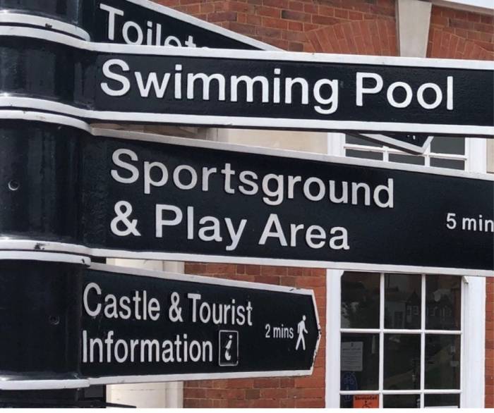 Town centre signposts to swimming pool and other locations.