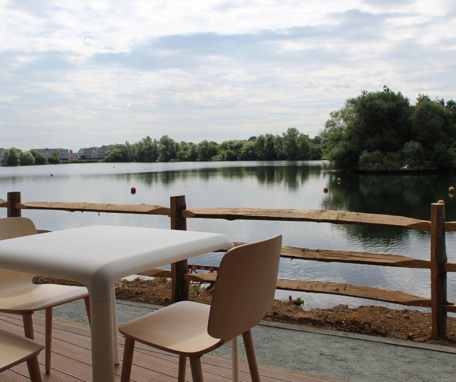 Table and chairs overlooking the lake at Leybourne Lakes Country Park.