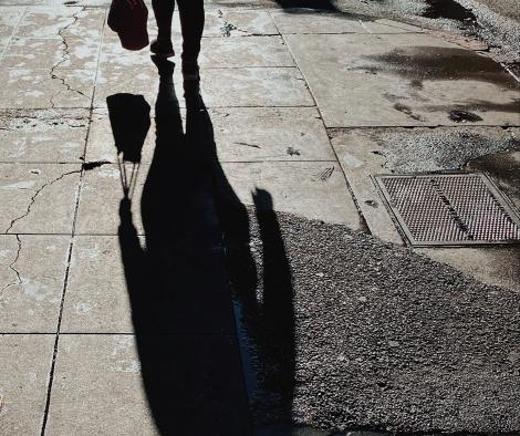 Woman in silhouette in dark street