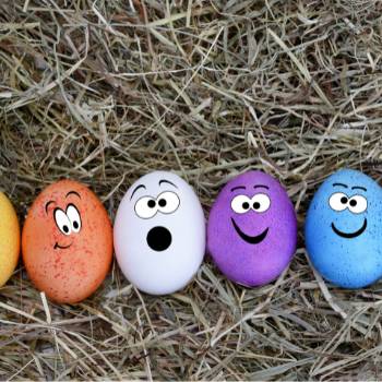 Four colourful eggs with painted faces