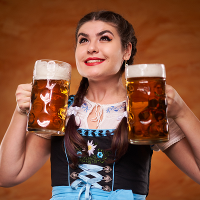 Woman dressed in German traditional dress with two glasses of beer