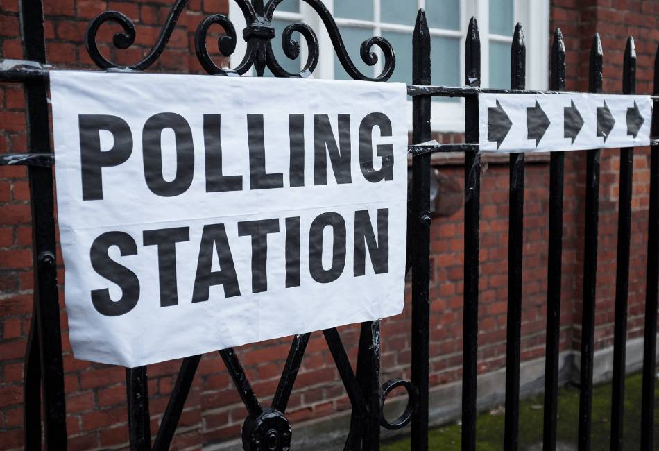 Polling station notice on an iron fence