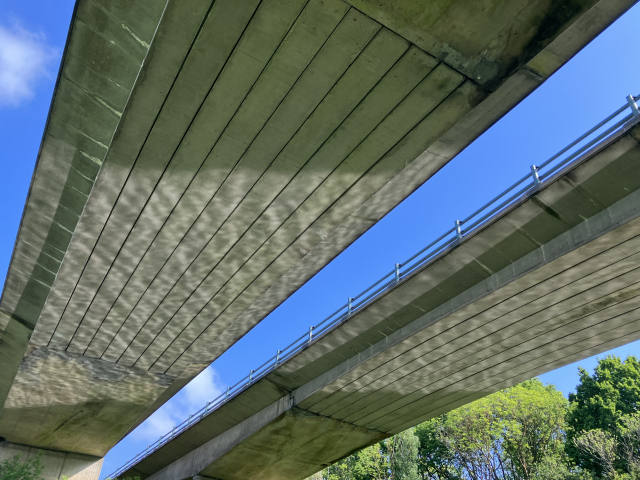 Reflection of water on the underside of a bridge