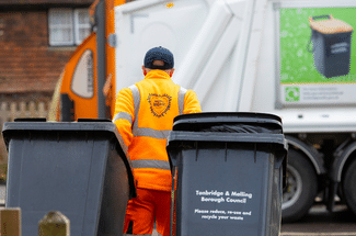 Bin man walking away from camera with wheelie bins